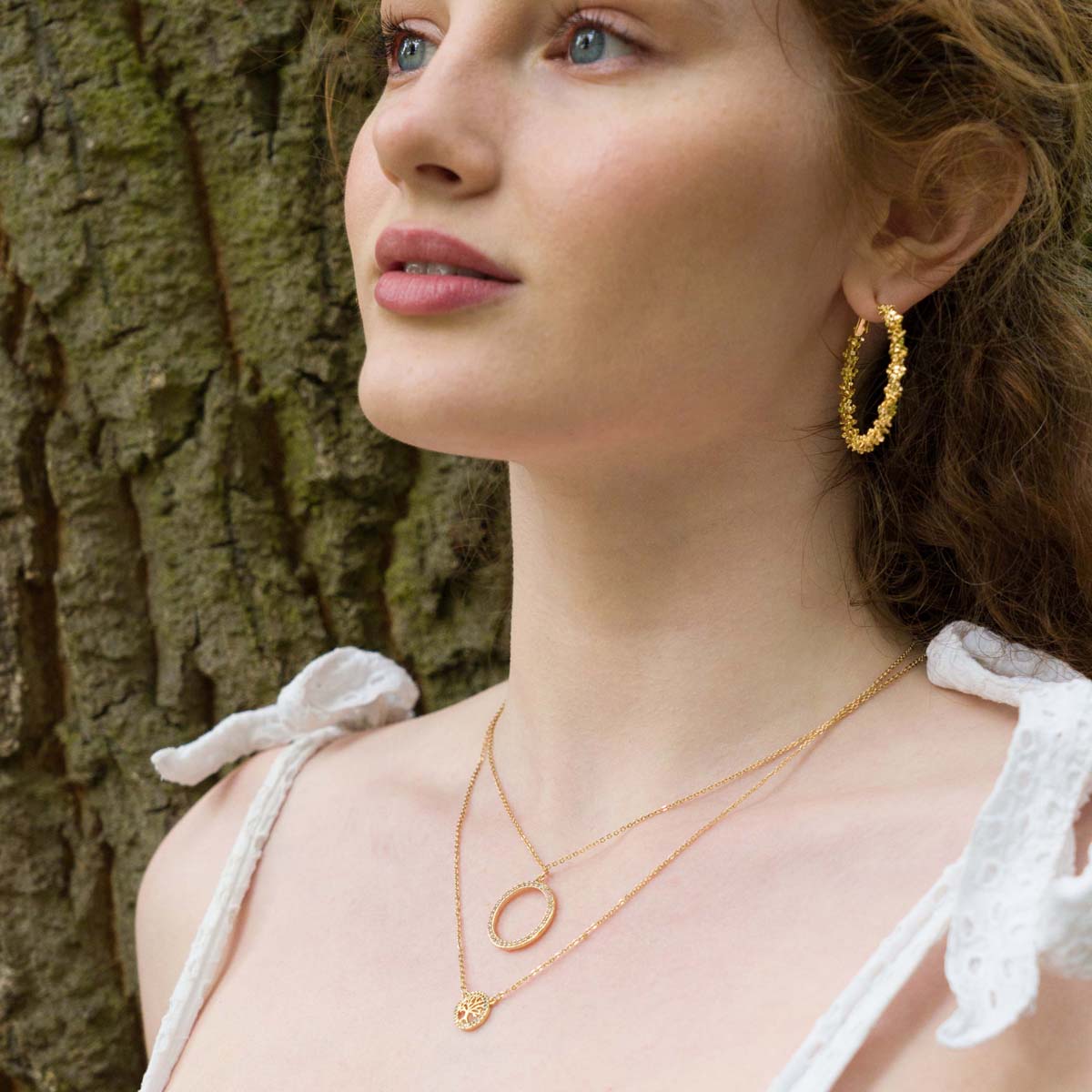 Model wearing Vivienne Textured Hoop Earrings In Gold