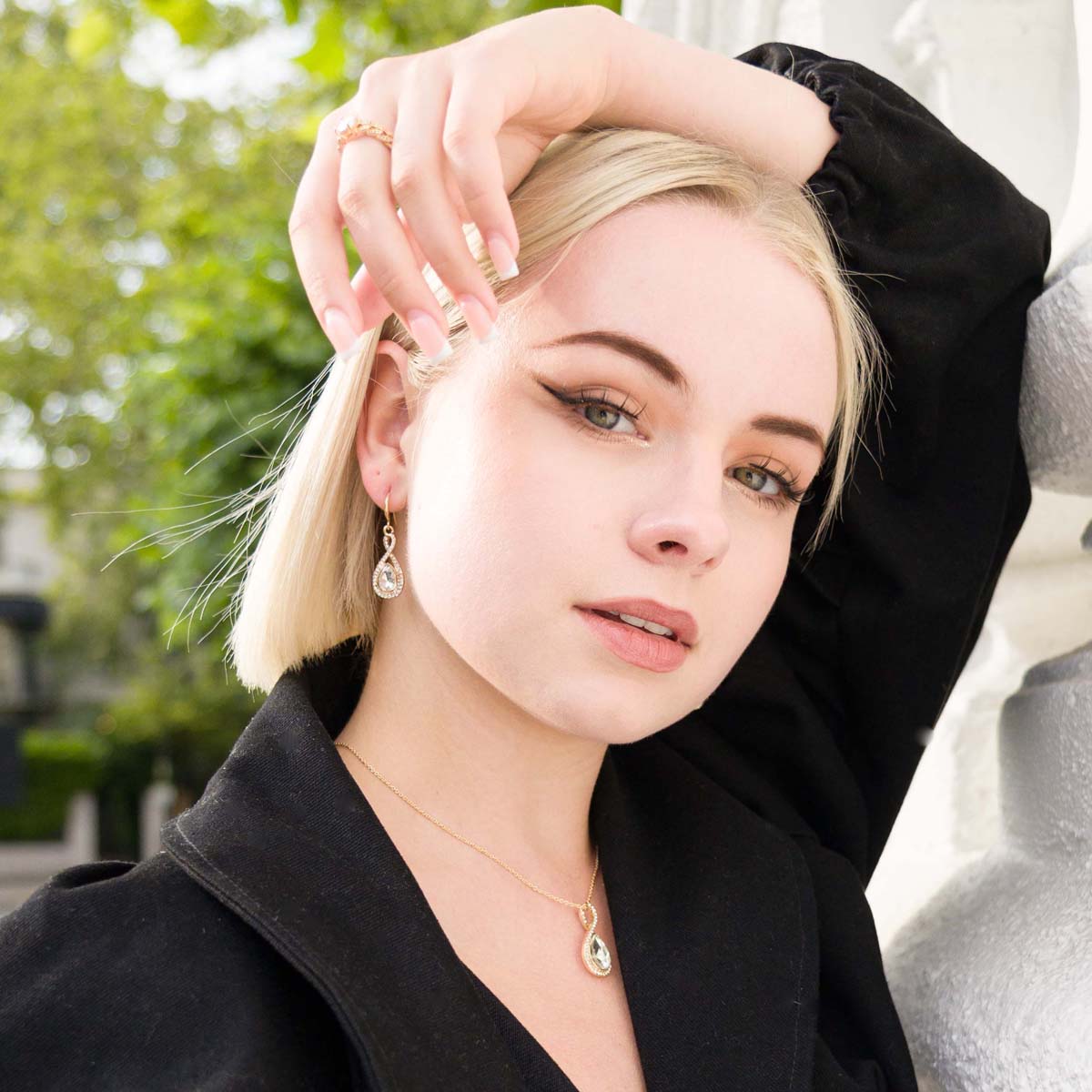 Model wearing Cubic Zirconia Infinity Teardrop Pendant Necklace & Earrings Set in Gold