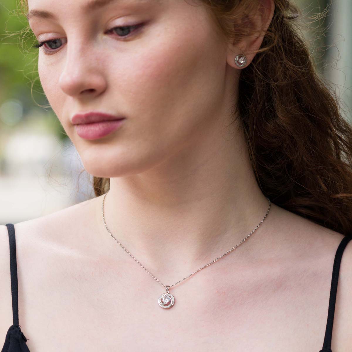 Model wearing Curling Cubic Zirconia Silver Necklace & Earring Jewellery Set