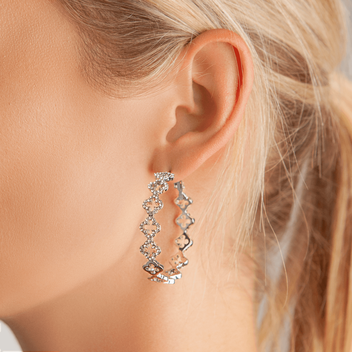Model wearing Vivienne Crystal Quatrefoil Hoop Earrings Silver