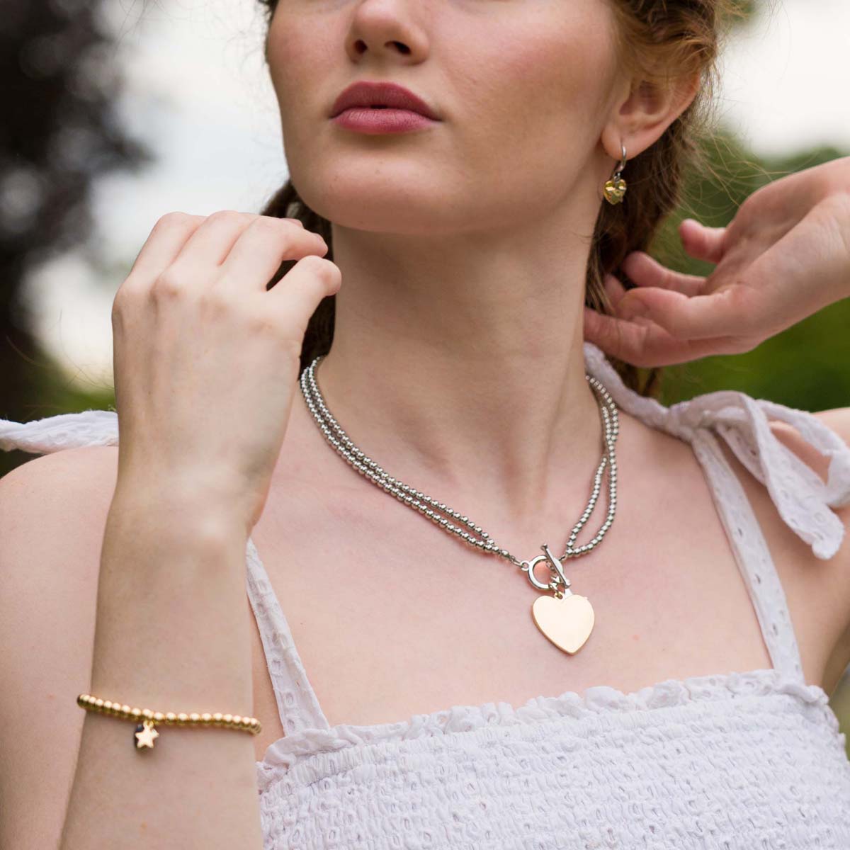 Model wearing Emily Heart and Star Necklace In Silver