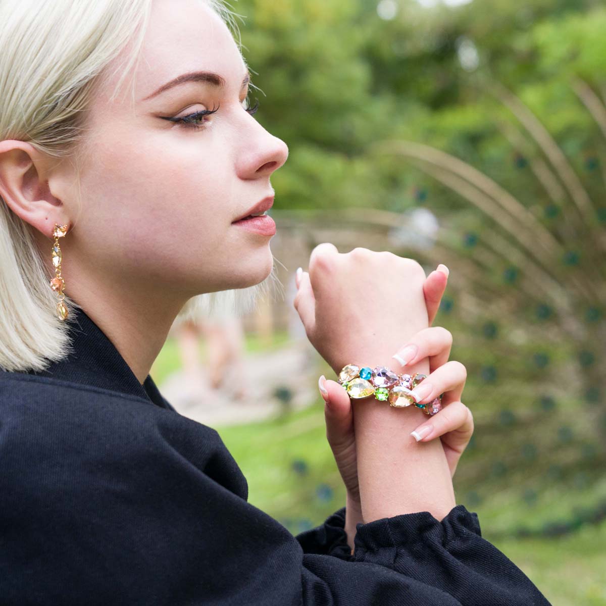 Model wearing Vivienne Gold & Multicoloured Crystal 4-Stone Dangle Earrings