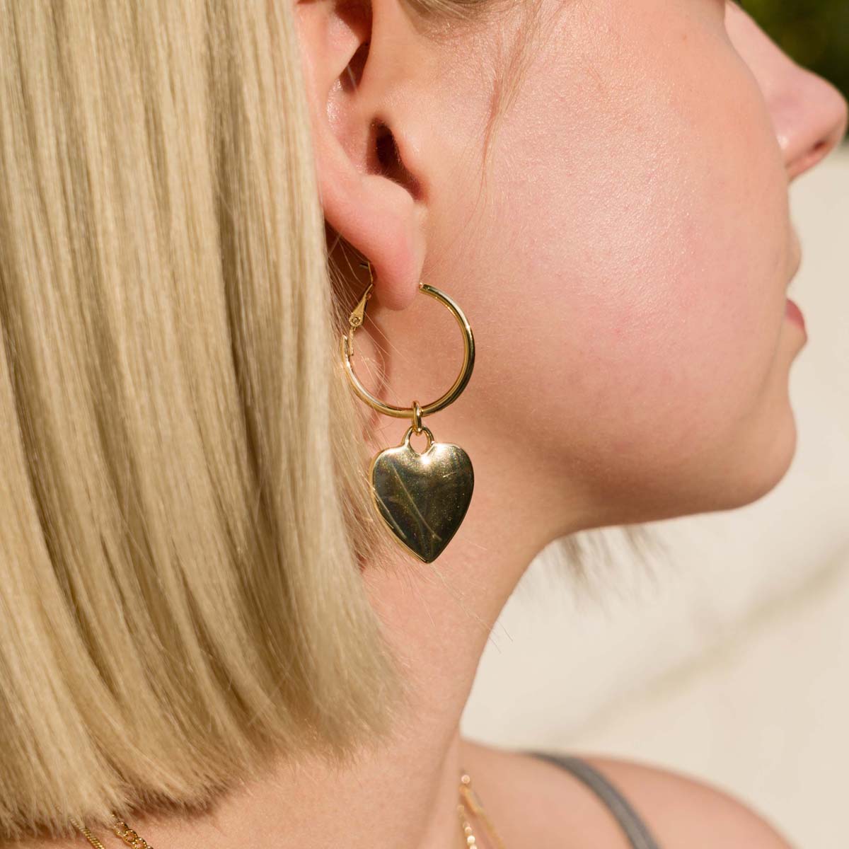 Model wearing Sweetheart Lever Earrings In Gold