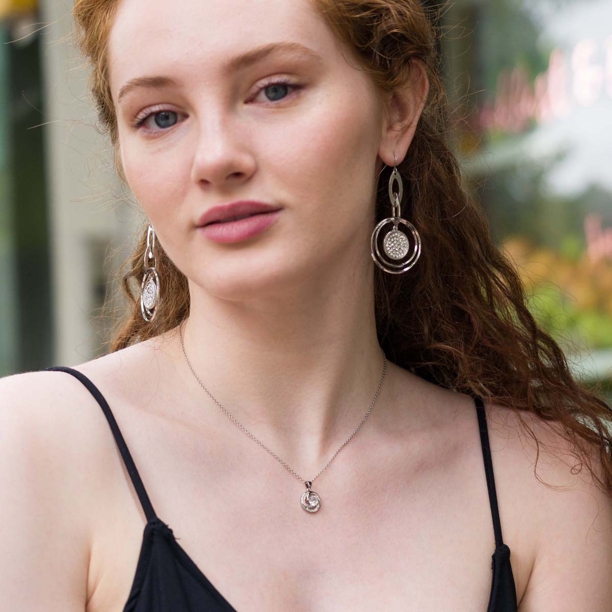 Model wearing Vivienne Crystal Geometric Dangle Earrings in Silver