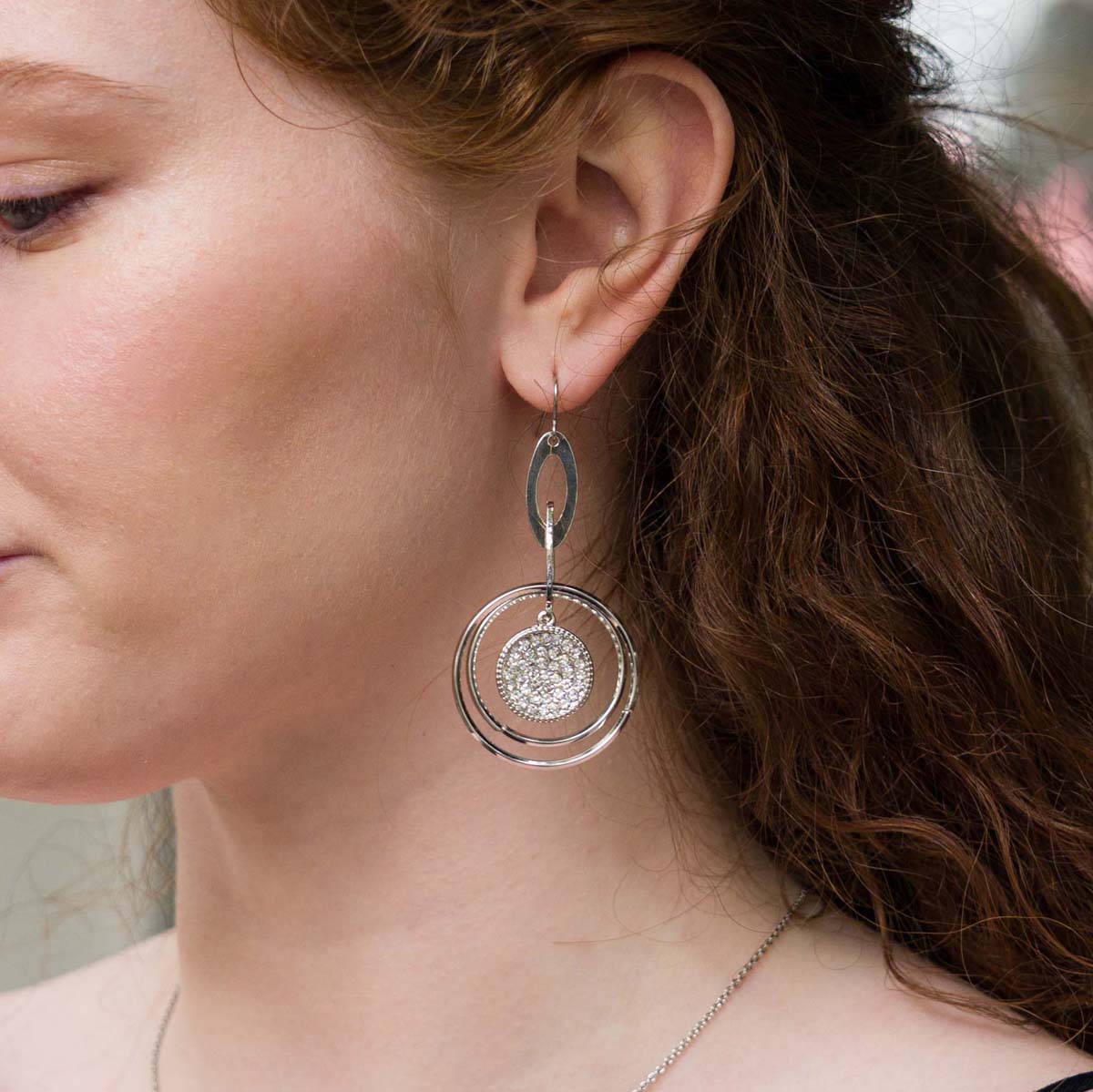 Model wearing Vivienne Crystal Geometric Dangle Earrings in Silver