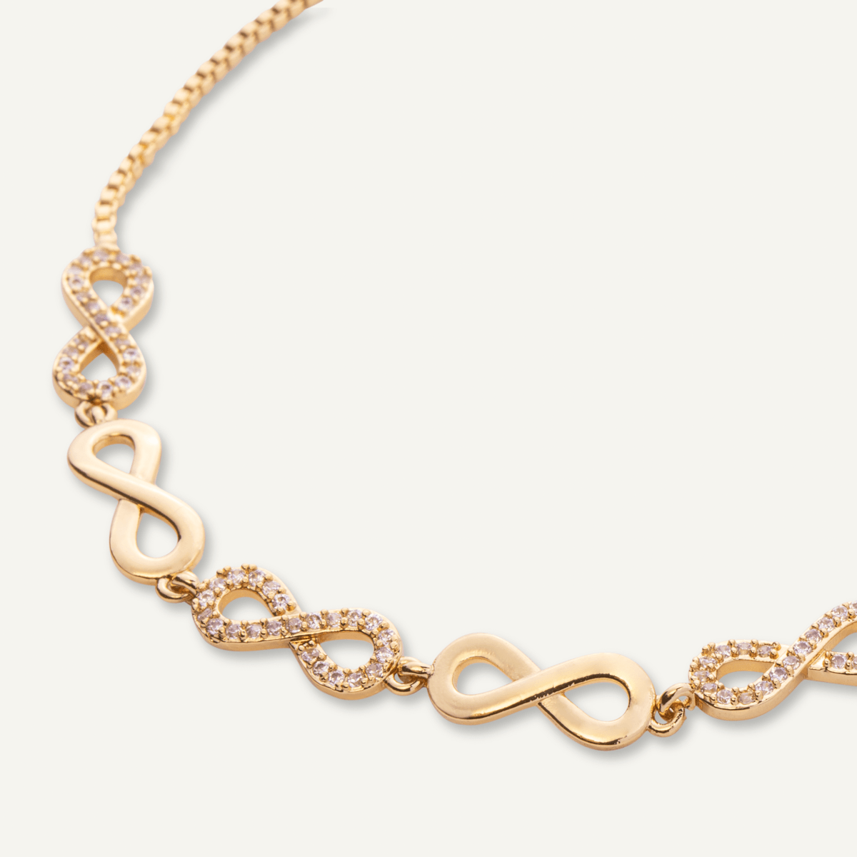 Close-up view of Keira Cubic Zirconia Infinity Drawstring Bracelet In Gold-Tone
