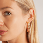 Model wearing Eternal Hearts Hoop Earrings in Gold