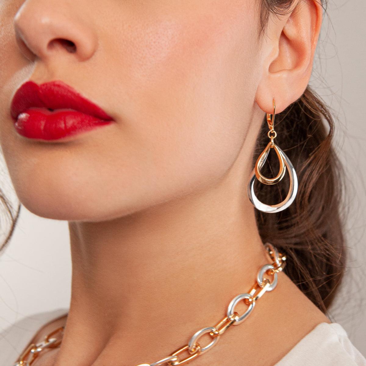 Model wearing Zaha Abstract Mixed Metal Lever Earrings in Gold