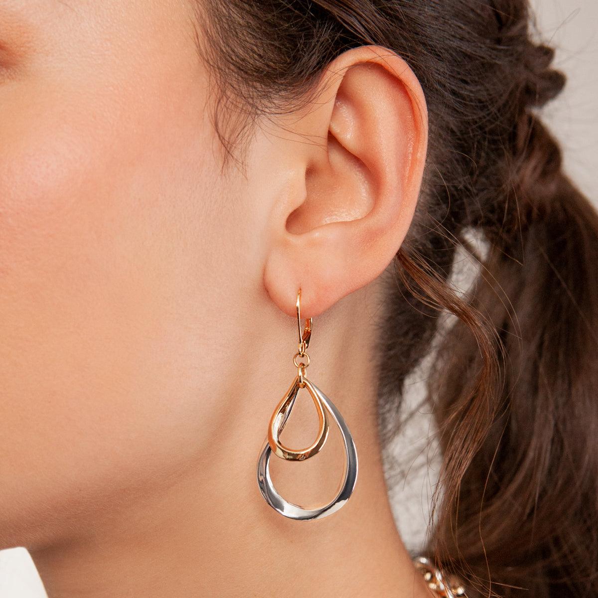 Model wearing Zaha Abstract Mixed Metal Lever Earrings in Gold