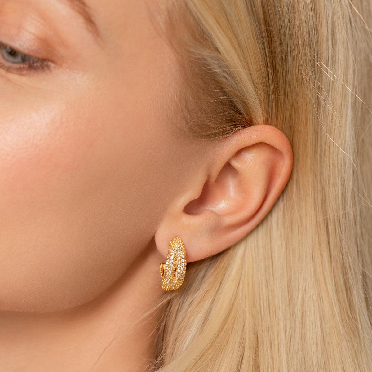 Model wearing Kylie Contemporary Abstract Crystal Earrings In Gold