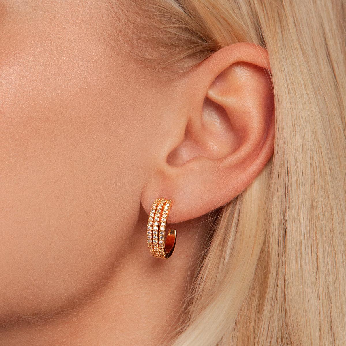 Model wearing Kylie Contemporary Crystal Earrings In Gold