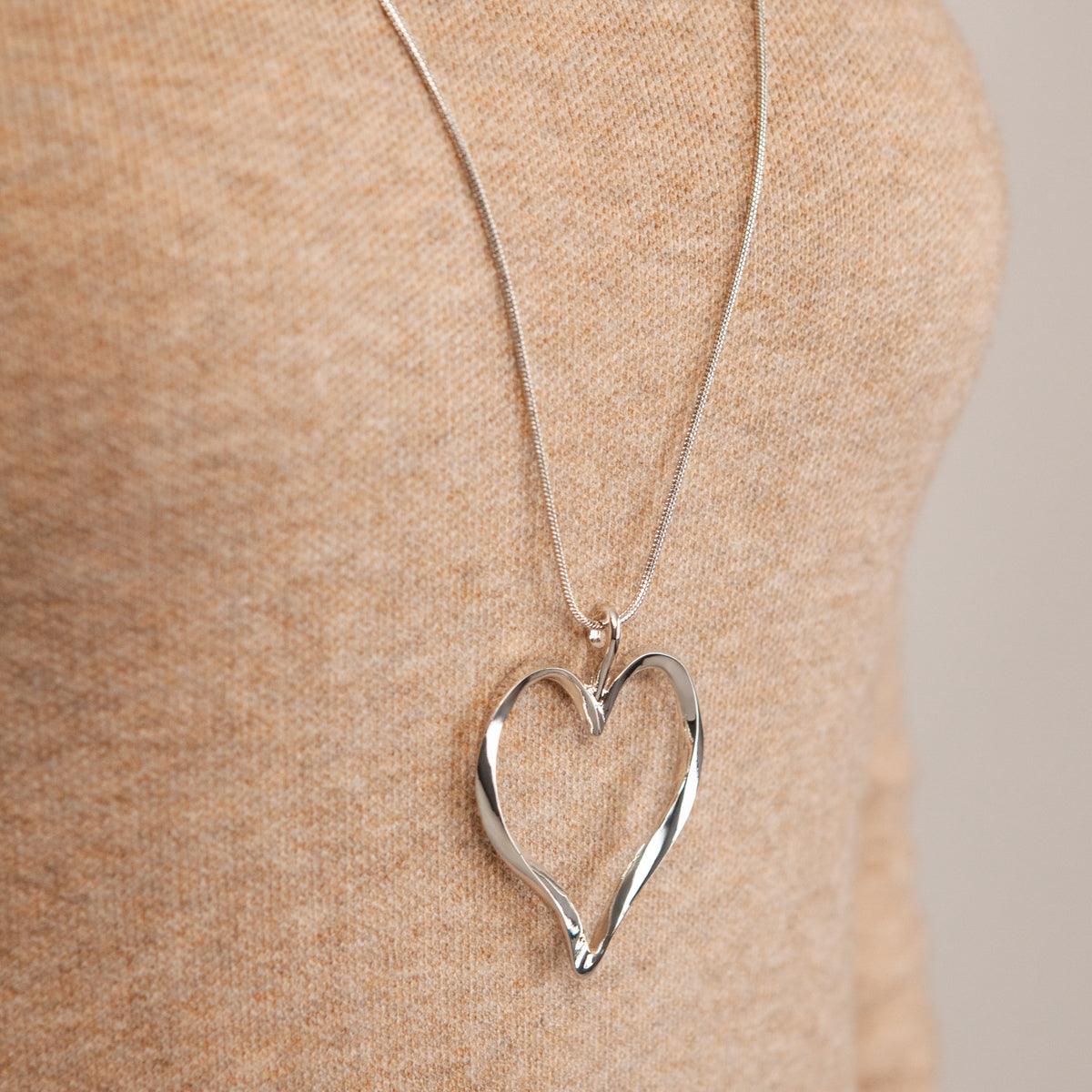 Model wearing Sweetheart Rhodium Silver Curved Heart Pendant Necklace