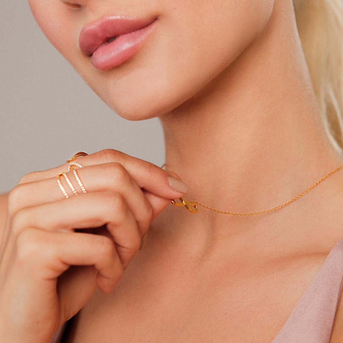 Model wearing Keira Infinity Symbol Pendant Necklace In Gold