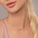 Model wearing Keira Infinity Symbol Pendant Necklace In Gold