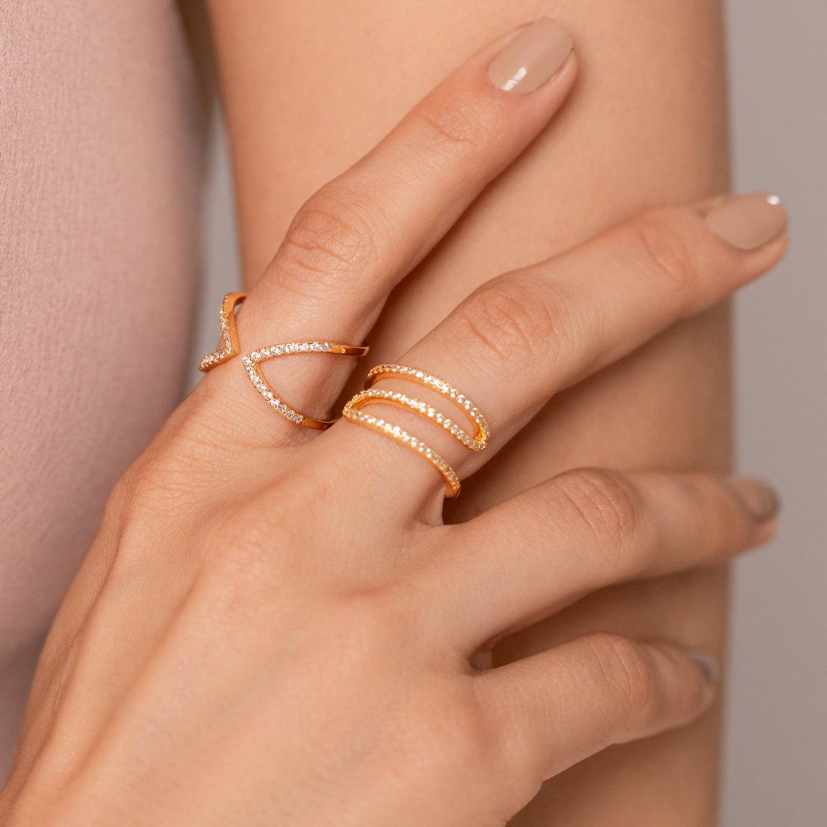 Model wearing Kylie Double Chevron Open Ring Gold Cubic Zirconia in Gold in close-up view