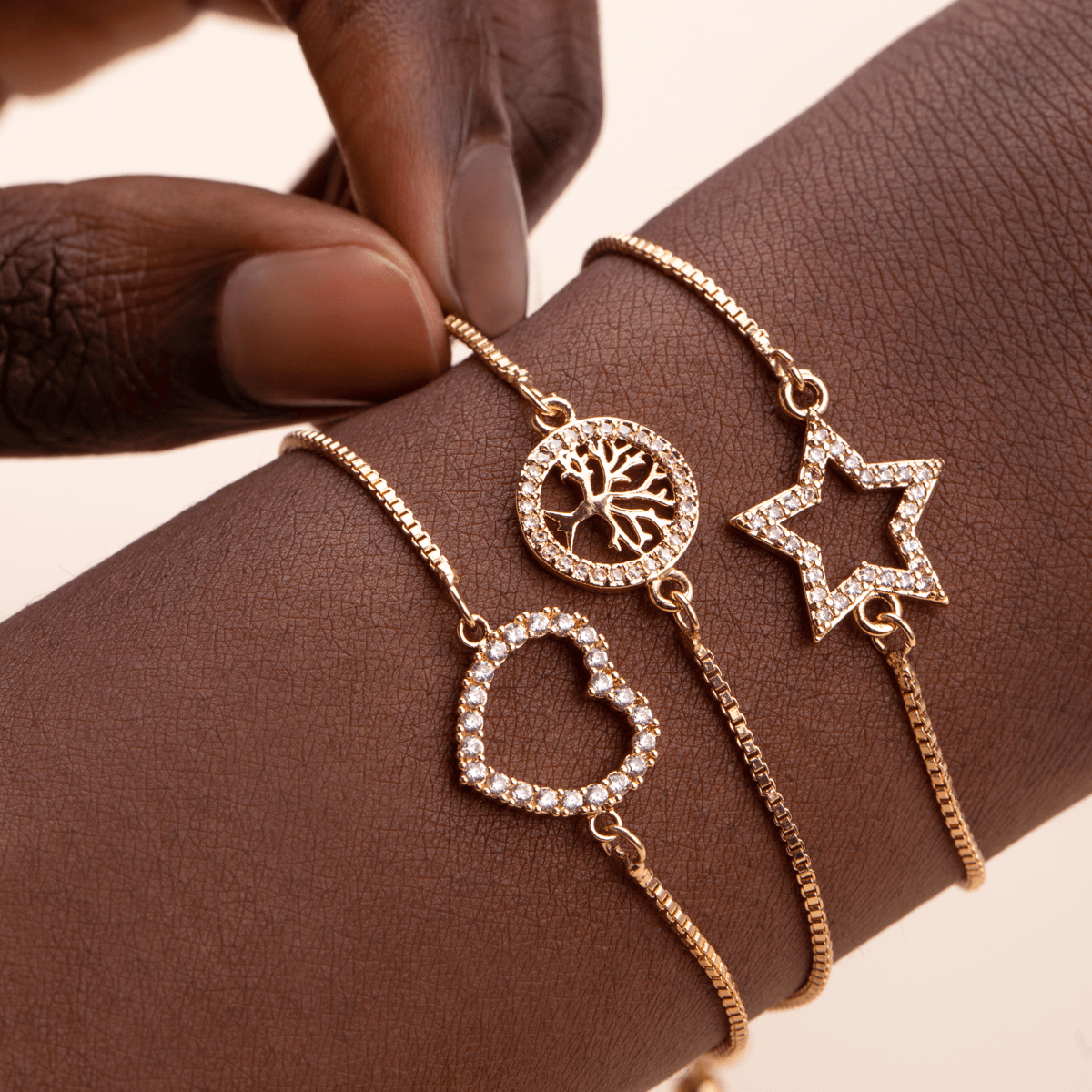 Close-up view of model wearing Vivienne Star Drawstring Bracelet in Gold Cubic Zirconia