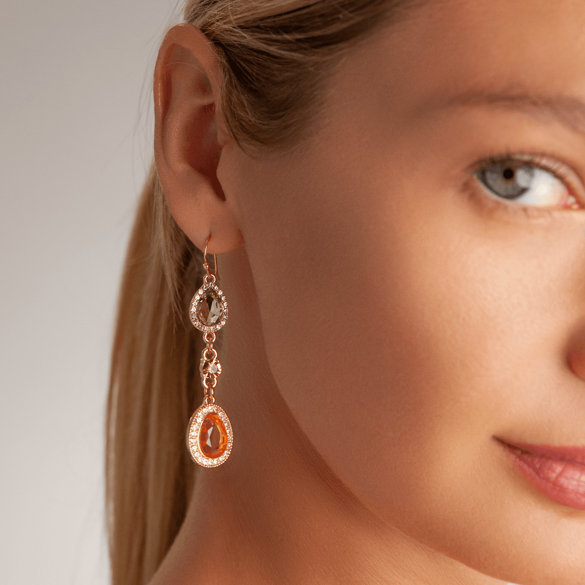 Model wearing Vivienne Gold & Multicoloured Crystal Teardrop Dangle Earrings