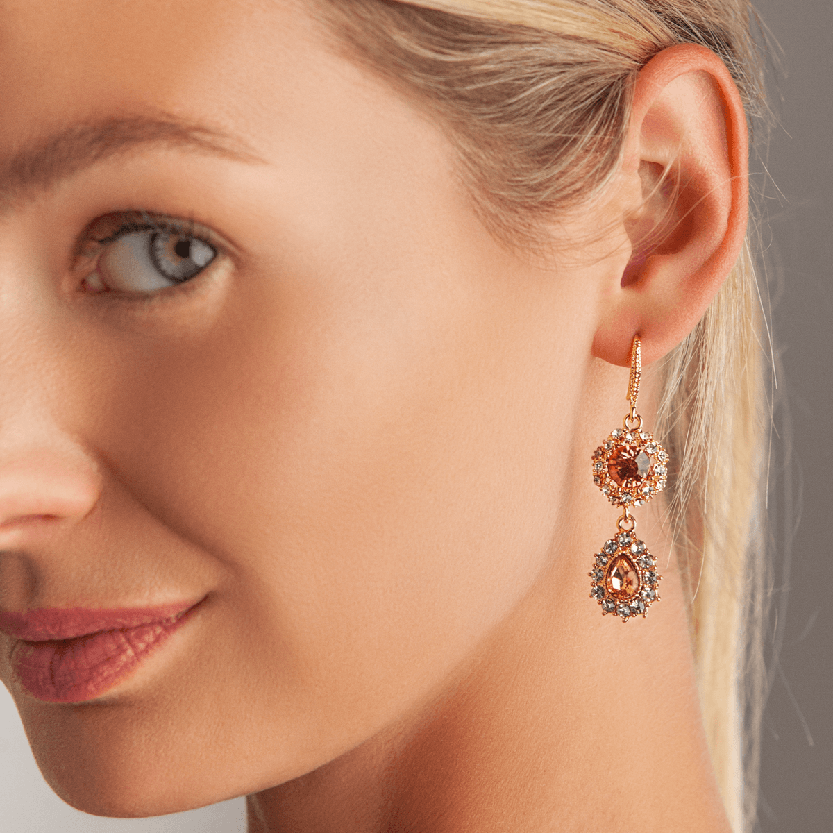 Model wearing Vivienne Gold & Peach Crystal Long Dangle Earrings