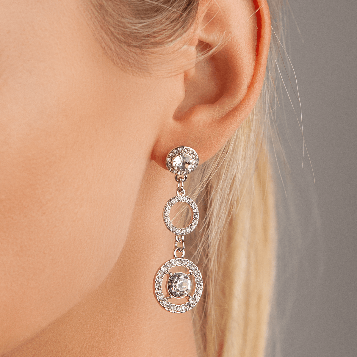 Model wearing Vivienne Silver Crystal Circle Link Drop Earrings
