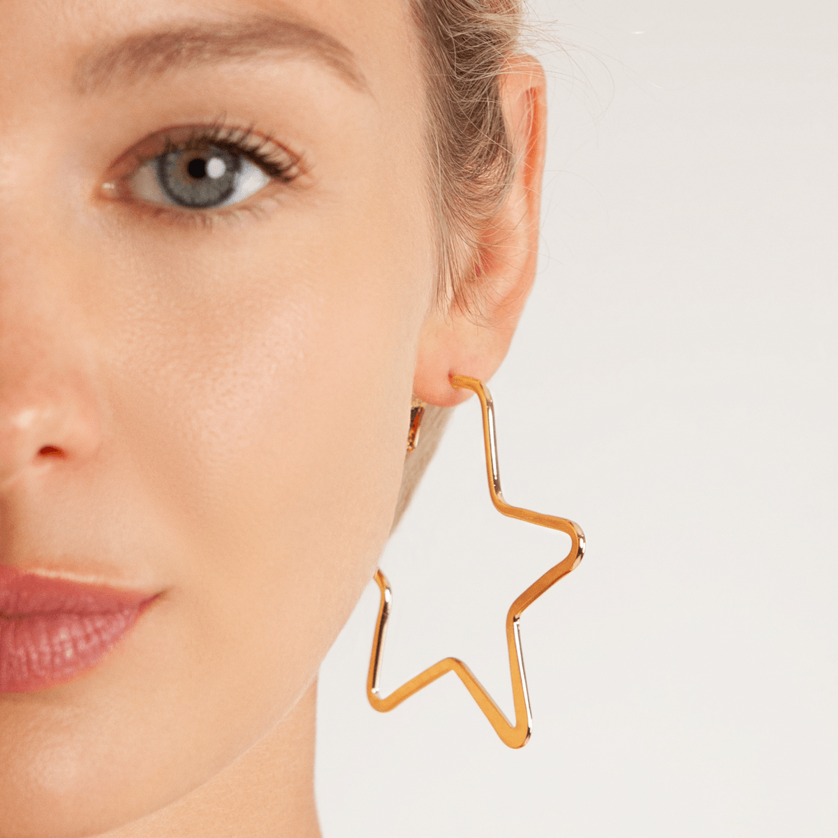 Model wearing Vivienne Star Hoop Earrings In Gold