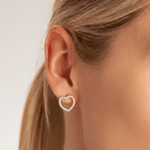 Model wearing Vivienne Heart Stud Earrings In White Gold & Cubic Zirconia