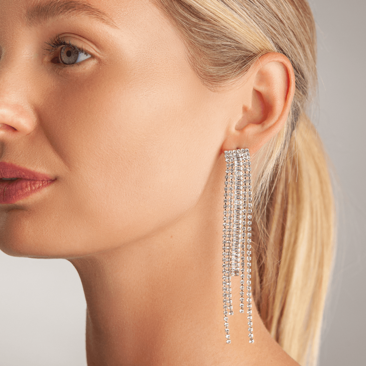 Model wearing Vivienne Fringed Dangle Earrings In White Gold Cubic Zirconia