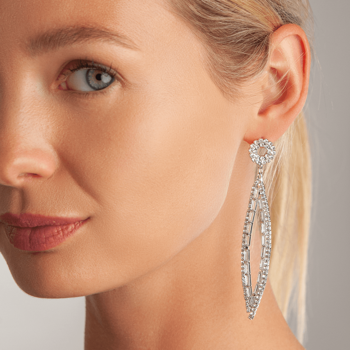 Model wearing Vivienne Geometric Marquise Dangle Earrings In White Gold