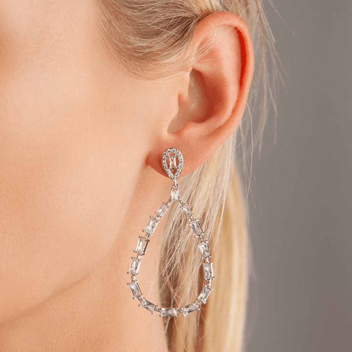 Model wearing Vivienne Teardrop Hoop Dangle Earrings In White Gold