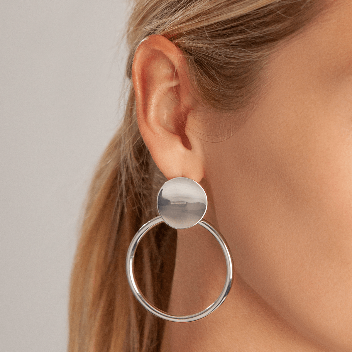 Model wearing Vivienne Circle Drop Earrings In White Gold