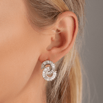 Model wearing Vivienne S-Curve Earrings White Gold & Cubic Zirconia