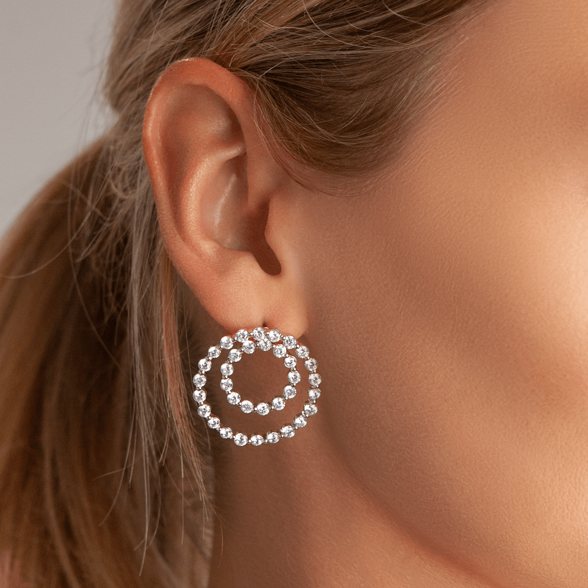 Model wearing Vivienne Double Circle Stud Earrings In White Gold & Cubic Zirconia