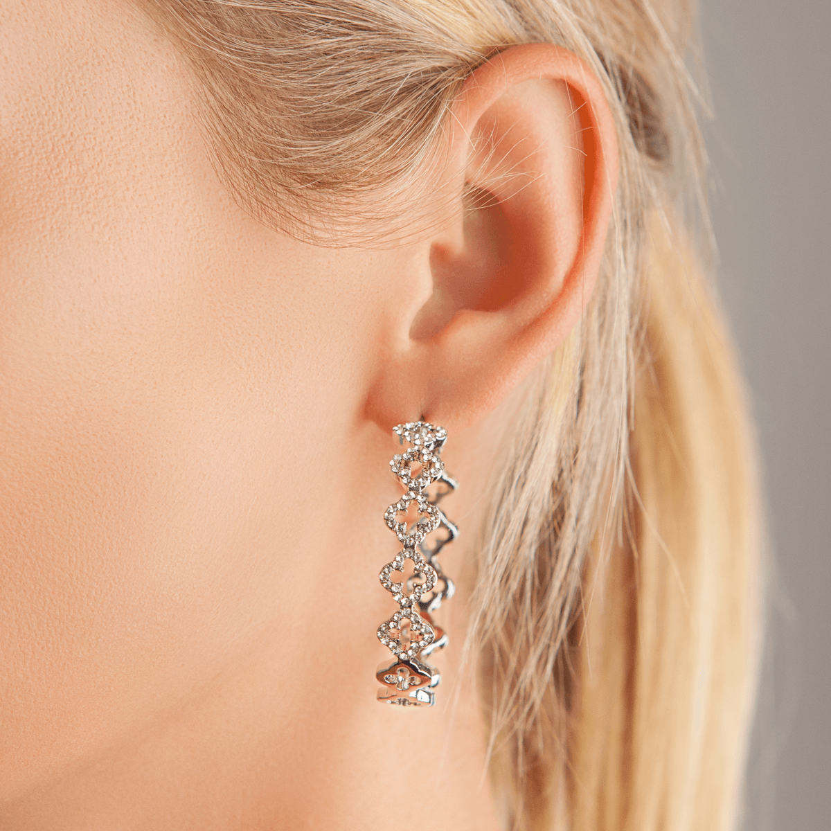 Model wearing Vivienne Crystal Quatrefoil Hoop Earrings Silver