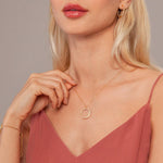 Model wearing Vivienne Circle Pendant Necklace in Gold & Cubic Zirconia