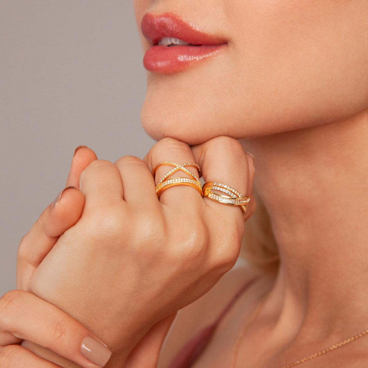 Model wearing Kylie Gold Cubic Zirconia Criss Cross Band Ring In Gold