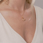 Model wearing Keira Gold Cubic Zirconia Intertwined Circle Necklace